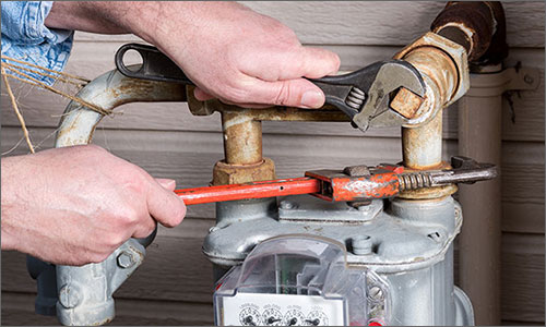 Utility Worker Adjusting Excess Flow Valve